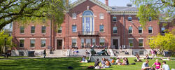 Brown University's campus lawn with students gathering outside.