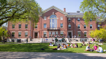 Brown University's campus lawn with students gathering outside.