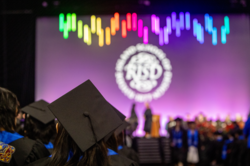 Image from a RISD Commencement ceremony of students looking toward a stage