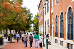 A group of people are walking outside of the RISD auditorium in downtown Providence, RI.