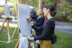 A first-year RISD student is drawing outside as part of their Experimental and Foundation Studies (EFS) program.